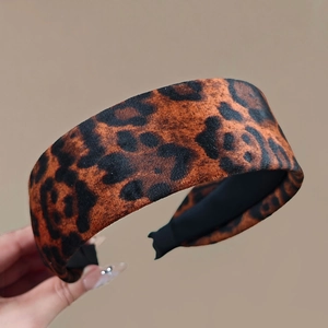 Detailed close-up of wide leopard print velvet headband with smooth black inner lining