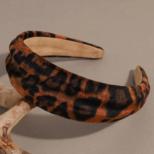 Macro detail of leopard print headband showing soft flocked velvet texture and pattern