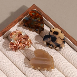 Set of four heart-shaped acetate hair clips in tortoiseshell and leopard patterns