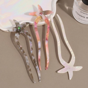 U-shaped acetate starfish hair pins set with rhinestone accents in iridescent colors