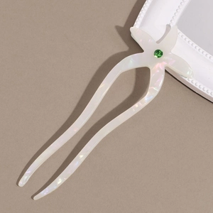 Detail of starfish acetate U-shaped hair pin with green crystal and pearlescent finish