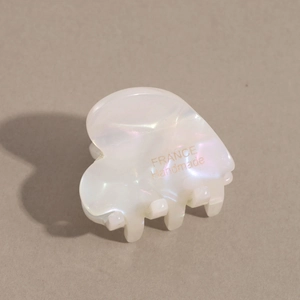 Detail of heart-shaped pearlescent acetate hair claw with France Handmade inscription