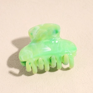Detail of light green marble texture resin hair claw clip with frosted matte finish
