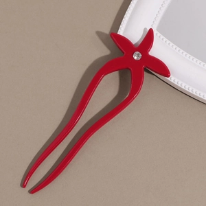 Detail view of red starfish acetate hair pin with crystal rhinestone for bun styling