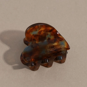 Detail of tortoise shell acetate hair clip featuring gold FRANCE Handmade lettering
