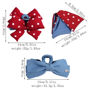 Detail view of denim and red polka dot bow hair claws with size and weight specs