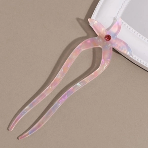 Detailed view of pink iridescent starfish hair fork with central red rhinestone inlay