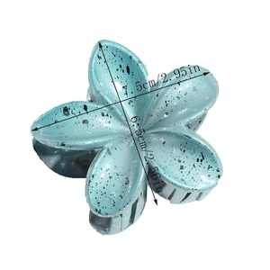 Detail view showing dimensions of a matte blue lily flower hair claw with ink splatter