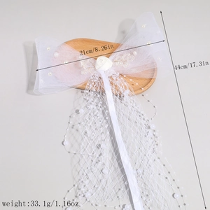 Detailed view of white tulle bow hair clip with pearls and rose, dimensions 21x44cm