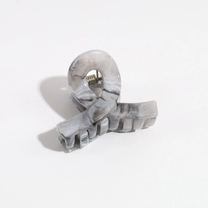 Close-up of matte marble textured hair claw clip with grey and white gradient pattern