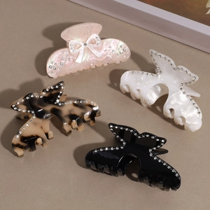 Set of four butterfly hair claws with rhinestones in pink, white, tortoise, and black