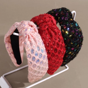 Three-pack knotted sequin headbands in pink, red, and black with shiny mesh texture