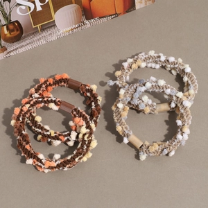 Set of four colorful plush sherpa bobble hair ties for winter fashion styling