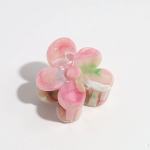Close-up of marble pink flower hair claw clip with acetate texture and smooth finish
