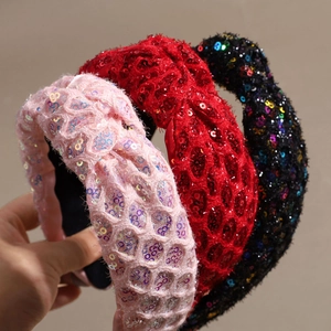 Three sequin knotted headbands in pink, red, and black with shiny woven mesh texture
