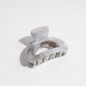 Detailed view of the marble pattern plastic hair claw clip with grey gradient texture