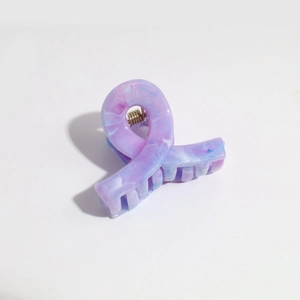 Macro view of purple and light blue gradient matte hair claw clip with metal spring