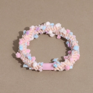 Detailed macro view of colorful pom-poms on a high elasticity spiral hair tie accessory