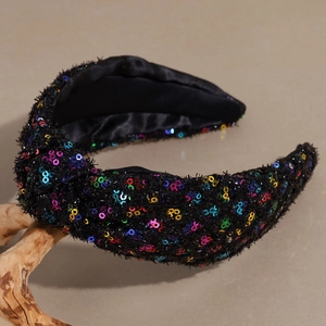 Close-up of knotted headband with multi-color sequins on a black fabric base