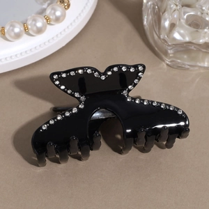 Close-up of black butterfly hair claw clip with sparkling rhinestones on the edges