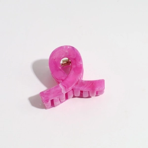 Detail of pink and white marble hair claw clip with golden metal spring mechanism