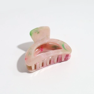 Detailed macro view of the marble texture on the pink and green gradient hair claw clip