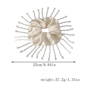Detail view of beige satin scrunchie with pearl tassels showing 25cm diameter size