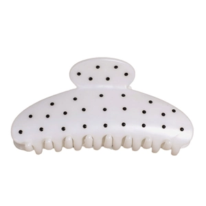Pince à cheveux à pois noirs sur fond blanc crème pour un style élégant
