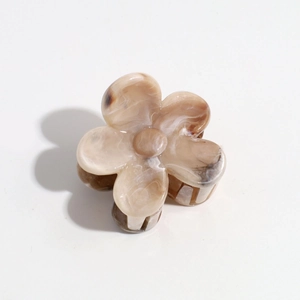 Close-up of floral hair claw clip featuring elegant coffee marble texture and matte finish