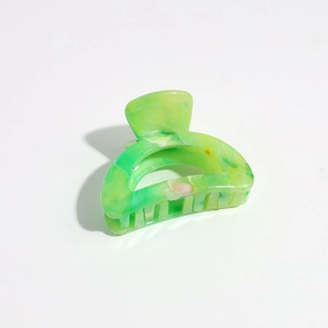 Detail view of green marble pattern plastic hair claw clip with strong matte teeth