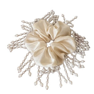Elegant satin scrunchie featuring decorative pearl fringe tassels in cream white