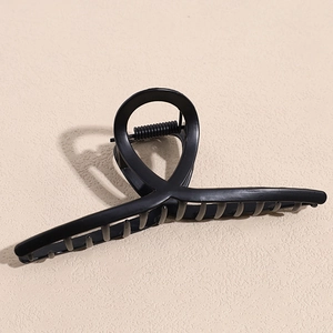 Matte black geometric claw clip with sturdy metal spring for hair styling