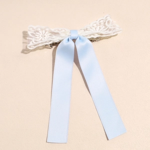 Detail von weißer Spitze und hellblauem Seidenband-Haarclip mit Metallverschluss