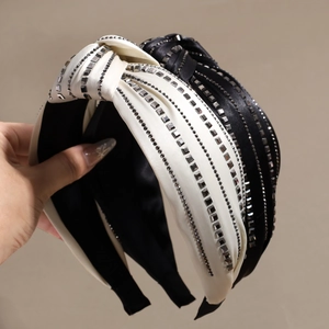 Padded knot headband with shimmering rhinestones in black and cream satin finish