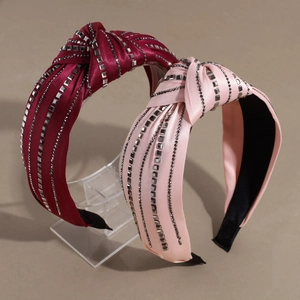 Knotted satin headbands in burgundy and light pink with shimmering rhinestone details