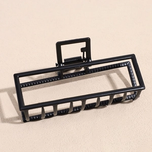 Close-up of matte black rectangular hollow hair claw clip with durable metal spring