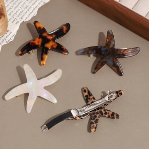 Starfish acetate hair clips set in tortoiseshell and leopard patterns with metal springs