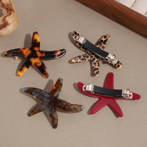 Starfish shaped acetate hair clips in tortoise shell and marble patterns with metal grips