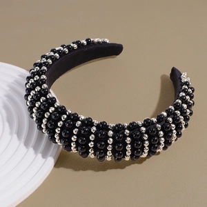 Detailed view of wide headband with black and silver beads on sponge fabric