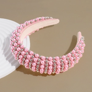 Detailed macro view of pink faux pearl headband with sparkling silver metal beads