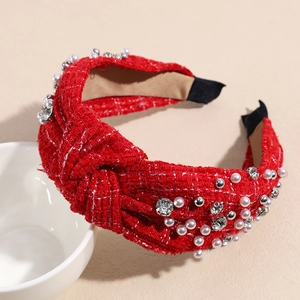 Detail of red tweed knot headband with white faux pearls and shiny rhinestones