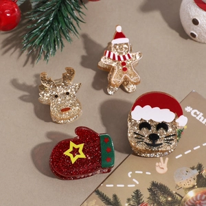 Christmas hair clips featuring golden reindeer, gingerbread man, and Santa cat details