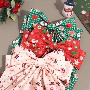 Three-piece Christmas bow hair clips featuring festive prints like Santa and Gingerbread man