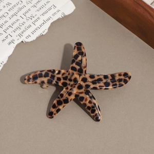 Detail view of starfish shaped leopard print acetate hair clip with metal spring back