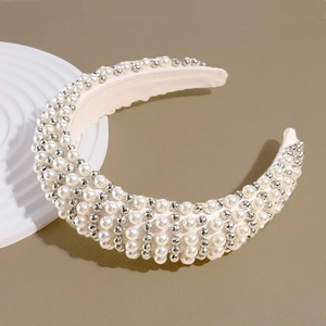 Detailed close-up of handmade baroque padded headband with white pearls and silver beads