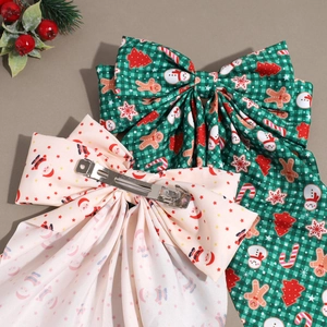 Christmas bow hair clips set with gingerbread man and santa claus prints on fabric