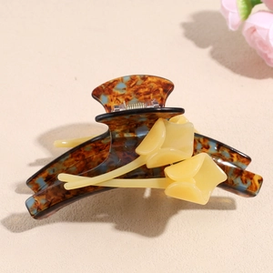 Detailed shot of tulip flower hair claw clip with brown tortoiseshell texture finish