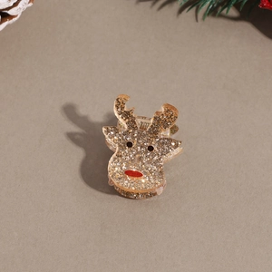 Close-up of a mini Christmas reindeer hair claw with gold glitter and red nose details