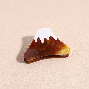 Detailed close-up of acetate Mount Fuji hair claw with tortoiseshell finish and fine glitter