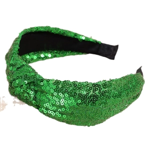 Sparkly green sequin knotted headband with wide festive design on white background